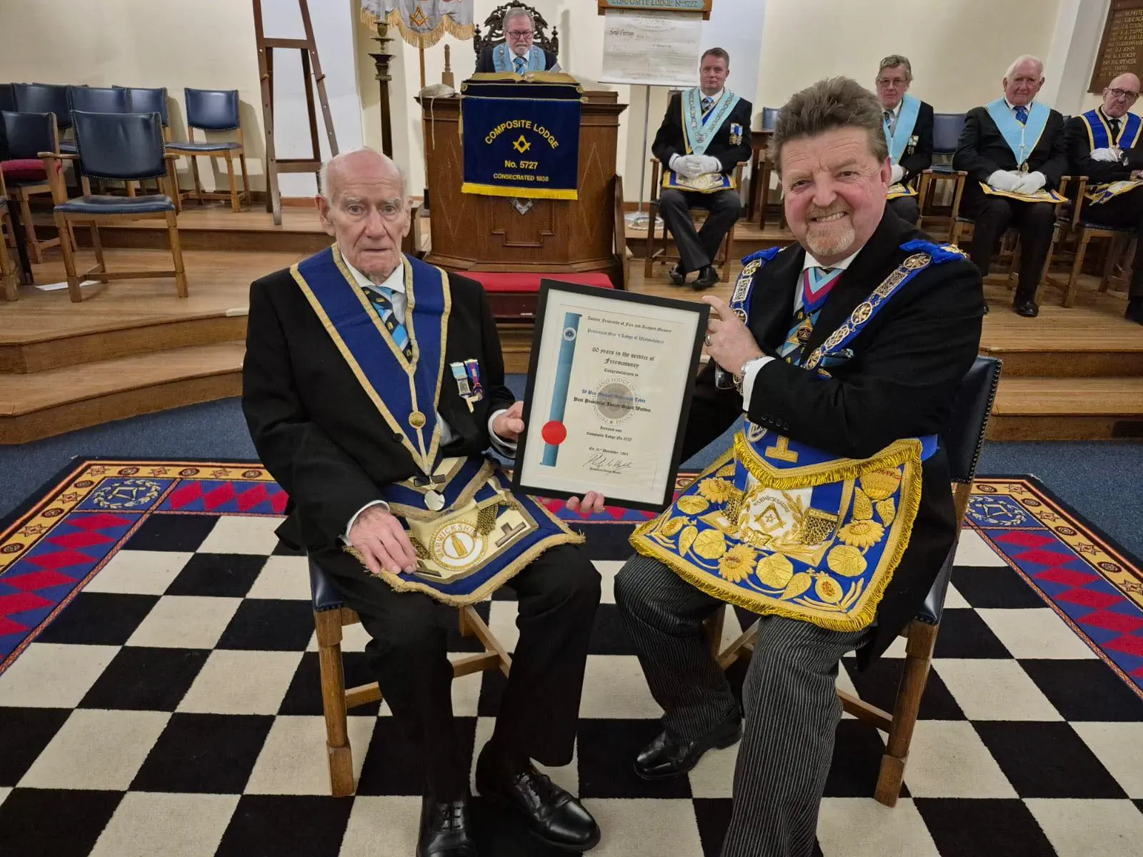 Michael Lovie receiving his 60-year long service award from Philip Hall